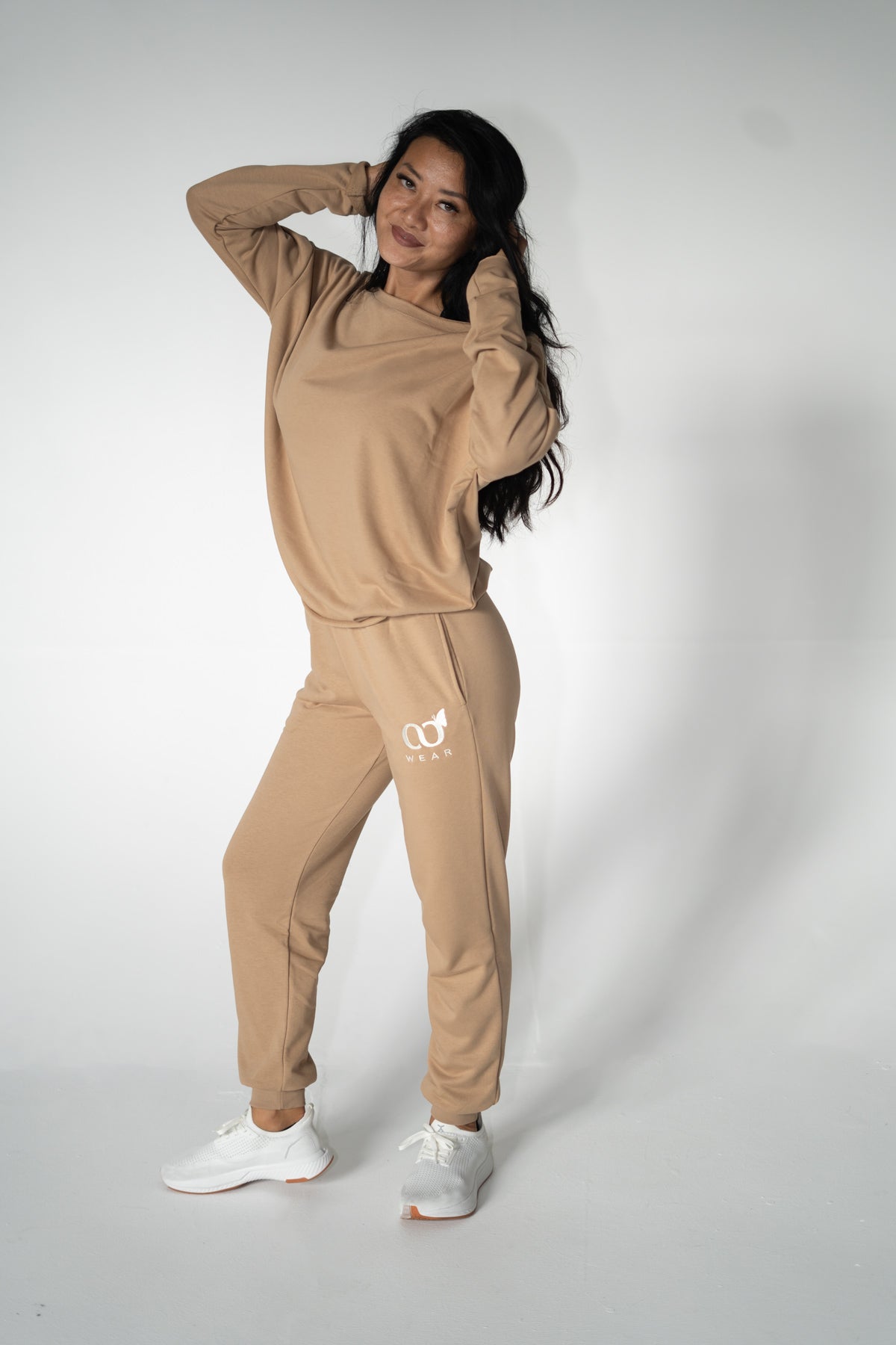This brown color 2-piece loungewear set for women, including a sweatshirt and pants. Designed for everyday comfort or travel, it offers a relaxed and laid-back style. Made from breathable, high-quality materials, it's both popular and sustainable, making it a must-have addition to any wardrobe.
