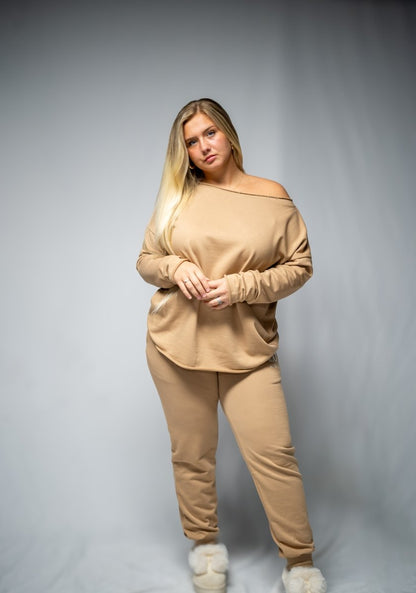 This brown color 2-piece loungewear set for women, including a sweatshirt and pants. Designed for everyday comfort or travel, it offers a relaxed and laid-back style. Made from breathable, high-quality materials, it's both popular and sustainable, making it a must-have addition to any wardrobe